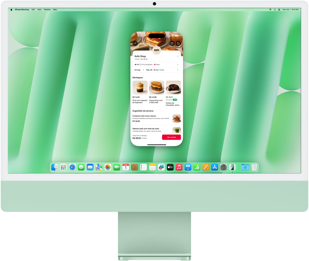 Demonstra??o do recurso Espelhamento do iPhone. Tela do iPhone mostrando o app Uber Eats duplicada e controlada no iMac.