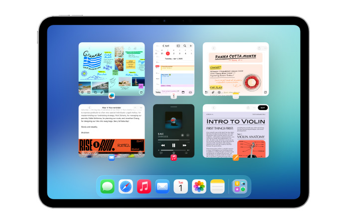 En iPad i vandret position viser flere apps som Kalender og Musik i seks vinduer i to r?kker, s? alle vinduer vises lige tydeligt.