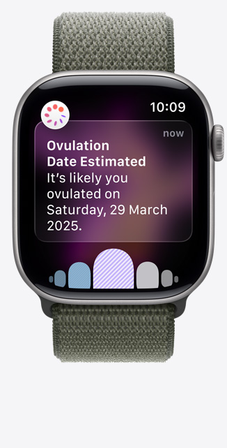 Apple?Watch Series?11，太空灰鋁金屬錶殼，展示透過(guò)健康?app 經(jīng)期追蹤收到的排卵日期推算通知、數(shù)碼錶冠，配搭森林色運(yùn)動(dòng)手環(huán)