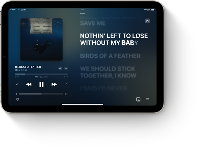 iPad mini oto?eny na ?írku, ktory zobrazuje Apple Music so slovami piesne.