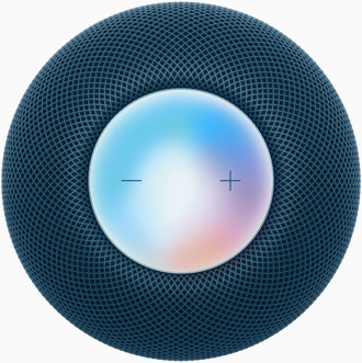 Blauwe HomePod mini van bovenaf gezien, met de twee volumeknoppen op een kleurrijke ondergrond.