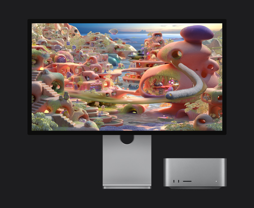 Dans un paysage de dessin animé sur un Studio Display XDR sous lequel est glissé un Mac Studio, une créature semblable à un ver sort d’un tunnel et traverse l’écran